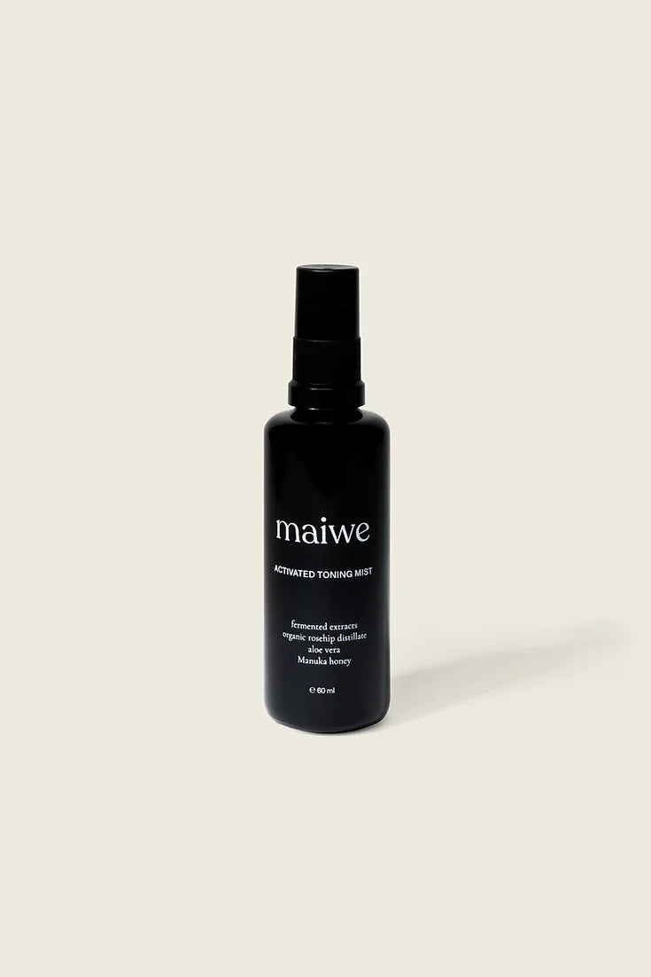 A black protective violet glass bottle with a fine mist sprayer labeled 'maiwe', containing the Activated Toning Mist.