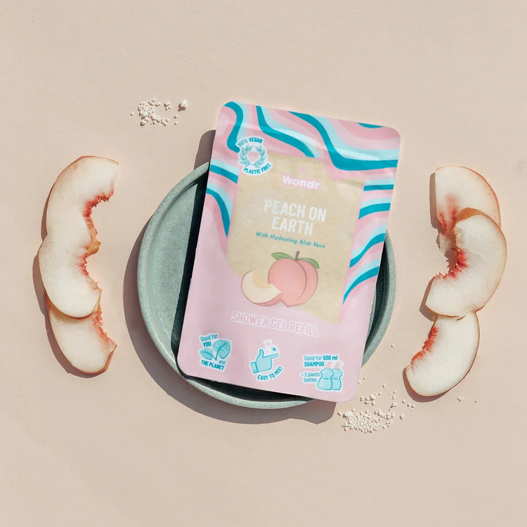 A package of Peach On Earth body wash refill with a visual representation of peach slices beside it.