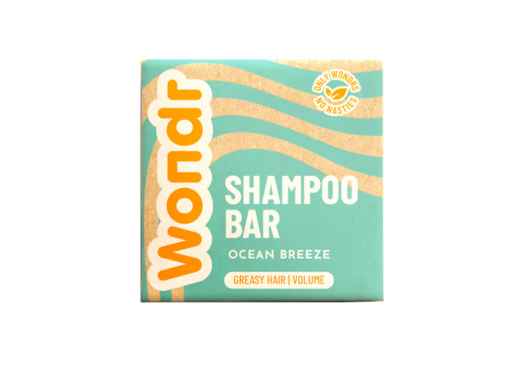 A packaged shampoo bar with 'WONDR SHAMPOO BAR OCEAN BREEZE' text on the box, indicating it is a vegan, sulfate-free product for greasy hair.