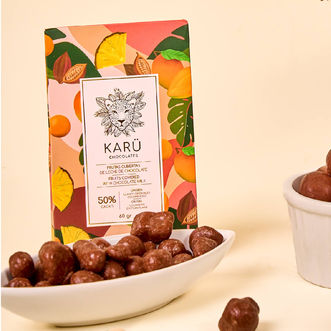 Karü chocolate-covered fruit box with containers filled with chocolate around it
