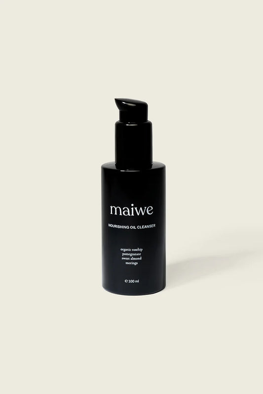 A black glass bottle with a pump dispenser labeled 'maiwe nourishing cleansing oil'.